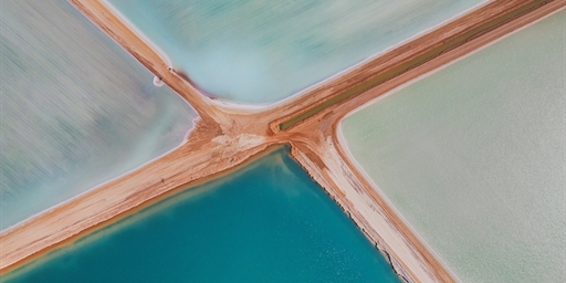dirt track roads across salt ponds in the shape of an X