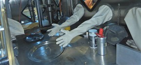 Person working with equipment in a glove box
