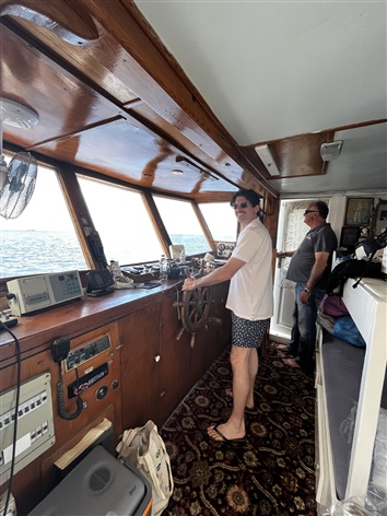 Man standing in the Bridge of a ship