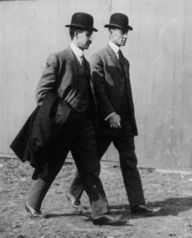 Two men walking side-by-side.