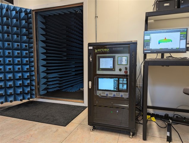 Entrance to sound proofed chamber with antennas test equipment and a computer.om