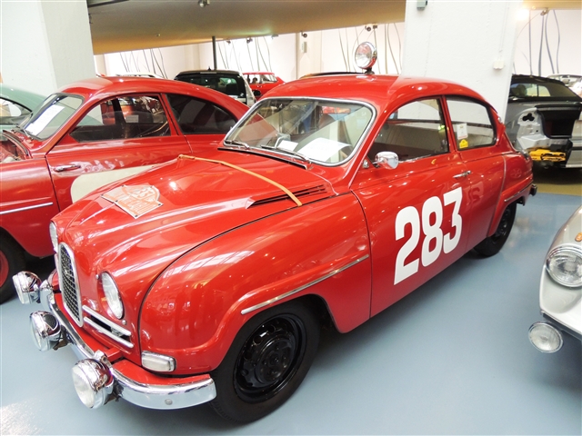 A red car with white numbers on the side