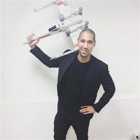 A man holding a model X-Wing fighter, from Star Wars 