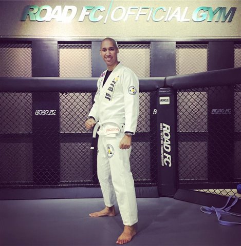A man posing in martial arts clothing