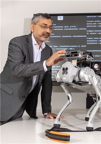 Man touching a robot dog