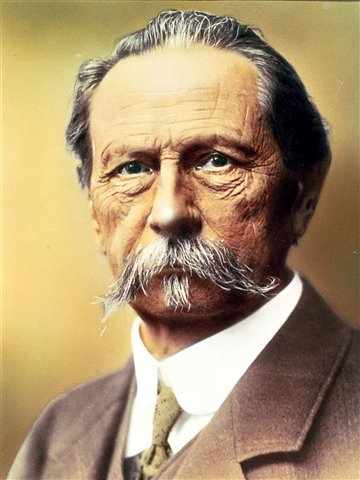 A man with a moustache and a suit