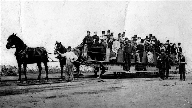 Horse drawn vehicle with people