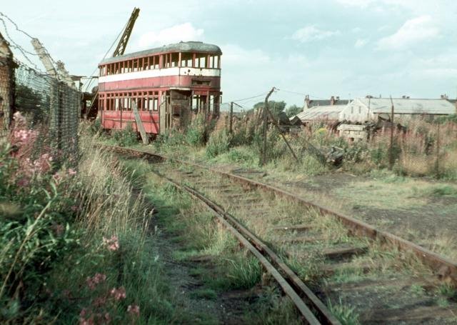 A wrecked tramcar in a scrapyward
