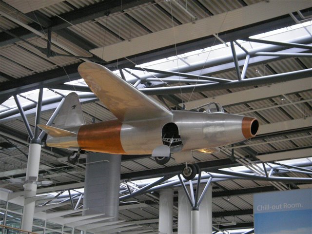 Single engined jet airplane hanging from an airport roof