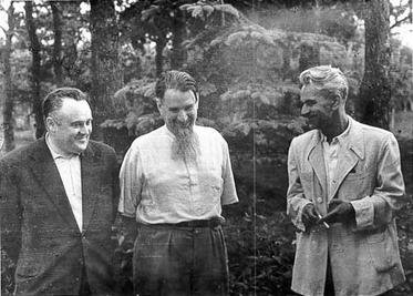 Three men standing beside each other